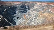 An aerial view of an open-cast gold mine.